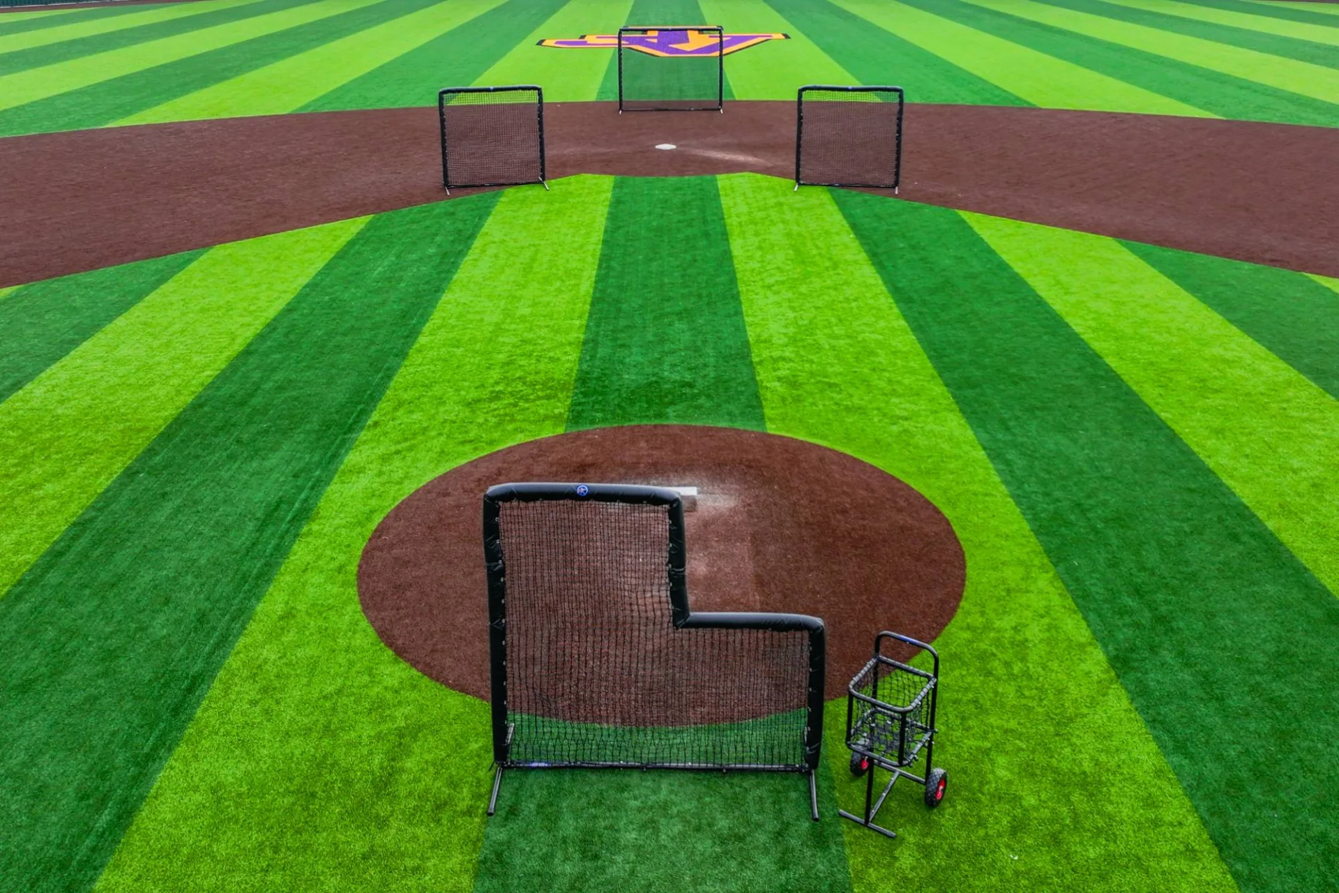 Batting screens staged across a baseball field for a product session