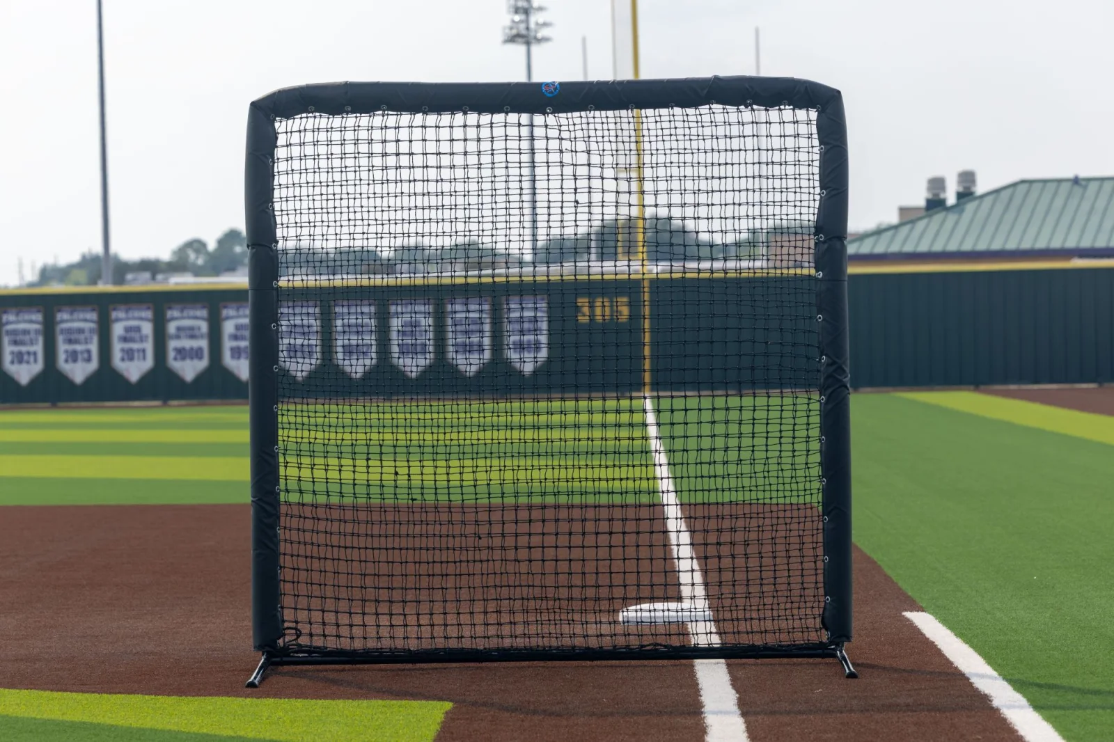 Square protective screen photographed against outfield championship banners