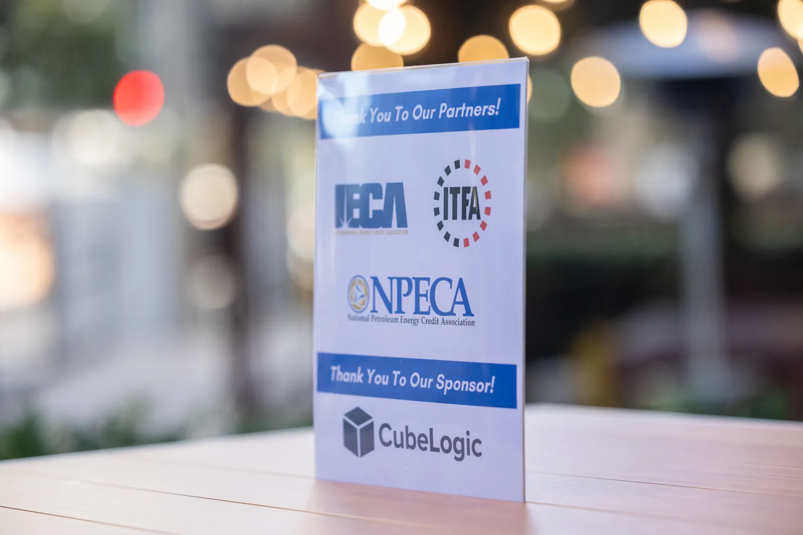Tabletop sponsor card thanking NPECA partners and the event sponsor